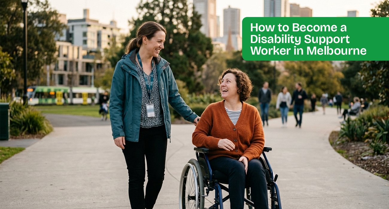 A smiling Melbourne Metro College student completing a supervised disability support worker placement with a woman in a wheelchair in a public Melbourne park, with the city skyline in the background. She is practicing person-centred care to increase social participation.