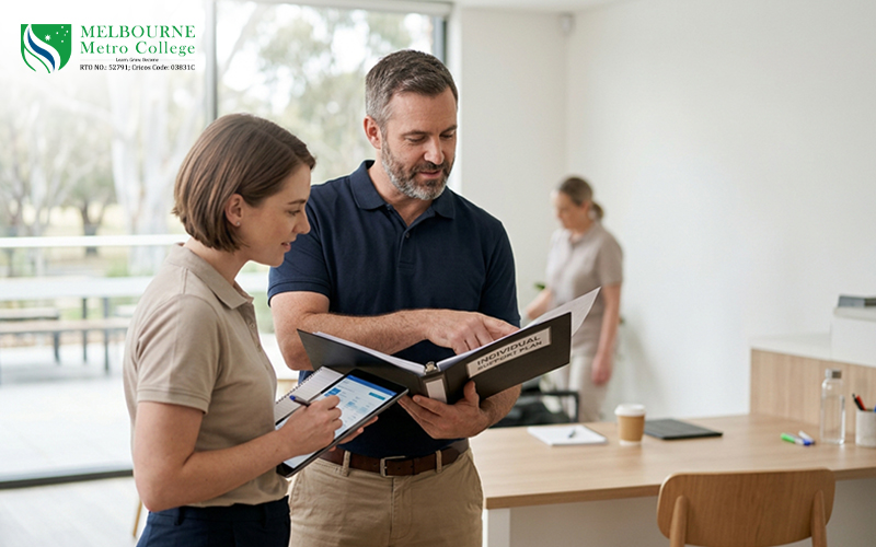 Experienced disability support workers reviewing an individual support plan together in a professional Australian community-care setting.