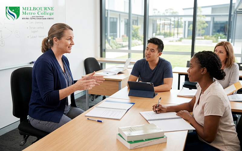 Adult vocational students learning disability support skills with a trainer in a practical classroom setting in Melbourne.