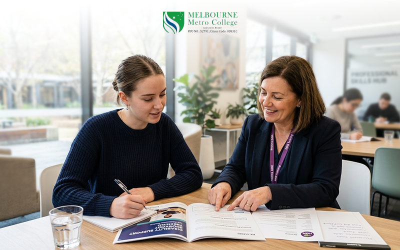 Adult learner receiving disability support training from a vocational trainer in a practical learning environment.